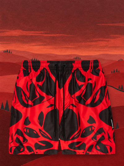 Czerwono-czarne szorty kąpielowe Strand Red w dolinie wzgórz z czerwonego papieru.